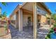 Outdoor patio featuring brick pavers, a covered dining area, and lush landscaping with a backyard view at 9215 Penn Station St, Las Vegas, NV 89123