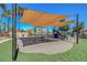 Spacious playground featuring shade structures and play equipment, set against a backdrop of mature palm trees at 9215 Penn Station St, Las Vegas, NV 89123