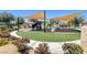 Community playground with modern play structures, swings, and seating, nestled amidst lush greenery at 9215 Penn Station St, Las Vegas, NV 89123