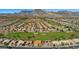 Stunning aerial view of the community nestled against a mountain range, featuring a golf course at 9409 January Dr, Las Vegas, NV 89134