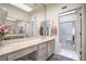 Bathroom with tile floors, long vanity with sink, large mirror, and a glass-door shower at 9409 January Dr, Las Vegas, NV 89134