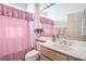 Bright bathroom featuring a large mirror, vanity, and a shower with a pink curtain at 9409 January Dr, Las Vegas, NV 89134