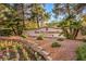 Beautifully landscaped entrance to the Sun City Summerlin, a Del Webb community, with colorful flowers and palm trees at 9409 January Dr, Las Vegas, NV 89134