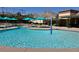 Inviting community pool with vibrant blue umbrellas, shallow wading area and mountain views at 9409 January Dr, Las Vegas, NV 89134