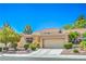 Charming home showcasing a well-manicured front yard, neutral stucco, and a tile roof at 9409 January Dr, Las Vegas, NV 89134