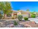 Well-maintained home with desert landscaping, two-car garage, and cozy outdoor seating area at 9409 January Dr, Las Vegas, NV 89134