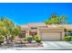 Charming single-story home featuring desert landscaping, a two-car garage, and a cozy front patio at 9409 January Dr, Las Vegas, NV 89134