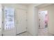 Bright foyer featuring tile floors, a white front door, and access to other rooms at 9409 January Dr, Las Vegas, NV 89134