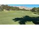 Scenic view of the lush green golf course with mountain backdrop, offering a perfect day of play at 9409 January Dr, Las Vegas, NV 89134