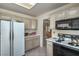 Cozy kitchen featuring white cabinets, appliances, and a skylight for natural light at 9409 January Dr, Las Vegas, NV 89134