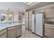 Bright kitchen with tile flooring, white cabinets and countertops, and stainless steel appliances at 9409 January Dr, Las Vegas, NV 89134