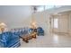 Bright living room with tile flooring, high ceilings, and comfortable blue furniture at 9409 January Dr, Las Vegas, NV 89134