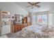 Bright main bedroom featuring carpet floors, a ceiling fan, and a big window with natural light at 9409 January Dr, Las Vegas, NV 89134