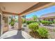 Inviting covered patio overlooking a well-maintained yard with lush greenery and mature trees at 9409 January Dr, Las Vegas, NV 89134