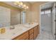 Bright bathroom with dual sinks, wood cabinets and a shower-tub combination at 9516 Belgate Ct, Las Vegas, NV 89129
