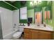 Bathroom features a shower-tub combination, vanity, and green accent walls at 9516 Belgate Ct, Las Vegas, NV 89129