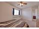 Neutral bedroom features built-in shelves, ample light, and neutral carpet at 9516 Belgate Ct, Las Vegas, NV 89129