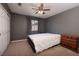 Cozy bedroom features neutral tones, carpet, and a ceiling fan for added comfort at 9516 Belgate Ct, Las Vegas, NV 89129