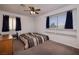 Neutral bedroom with ceiling fan, built in shelves and curtains for privacy at 9516 Belgate Ct, Las Vegas, NV 89129