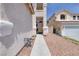 Charming entry to home with desert landscaping, a covered porch, and secure gated side yard at 9516 Belgate Ct, Las Vegas, NV 89129
