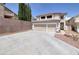 Lovely two-story home featuring a three-car garage and a low-maintenance desert-landscaped yard at 9516 Belgate Ct, Las Vegas, NV 89129