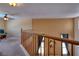 Second-story hallway featuring wood railing and view into the main level at 9516 Belgate Ct, Las Vegas, NV 89129