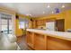 Bright kitchen featuring wooden cabinets, a white countertop, and an adjacent living area at 9516 Belgate Ct, Las Vegas, NV 89129