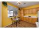 Bright kitchen with wood cabinets, eat-in table and chairs, and backyard views at 9516 Belgate Ct, Las Vegas, NV 89129