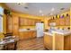 Bright kitchen featuring wooden cabinets and a breakfast table, with tile countertops at 9516 Belgate Ct, Las Vegas, NV 89129