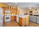 Open-concept kitchen boasts stainless appliances, white counters, and seamless flow to the living area at 9516 Belgate Ct, Las Vegas, NV 89129