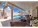 Relaxing covered patio area overlooks a sparkling pool and beautifully landscaped backyard at 9516 Belgate Ct, Las Vegas, NV 89129