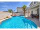 Backyard pool with waterfall feature and patio seating at 9516 Belgate Ct, Las Vegas, NV 89129