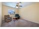 Cozy sitting area features two armchairs, small wood table, and natural light at 9516 Belgate Ct, Las Vegas, NV 89129