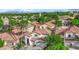 Expansive aerial view of a tile roof home in a lush, green community at 9705 Cameo Rose Ln, Las Vegas, NV 89134