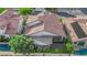 Rear aerial view of a home with a tile roof and a backyard patio at 9705 Cameo Rose Ln, Las Vegas, NV 89134