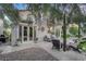 Covered patio with lounge chairs, lush landscape, stone details, and an open-air, relaxing feel at 9705 Cameo Rose Ln, Las Vegas, NV 89134