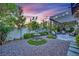 Serene backyard featuring a fountain, pergola, stone pavers, and lush landscaping at 9705 Cameo Rose Ln, Las Vegas, NV 89134