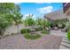 Charming backyard garden with a fountain and a pergola-covered patio seating area at 9705 Cameo Rose Ln, Las Vegas, NV 89134
