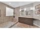 Bathroom features double sinks, modern tile, walk in shower, and large windows at 9705 Cameo Rose Ln, Las Vegas, NV 89134
