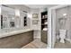 Elegant bathroom with double vanities, dark wood cabinets, and access to a separate toilet room at 9705 Cameo Rose Ln, Las Vegas, NV 89134