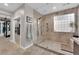 Modern bathroom featuring a glass-enclosed shower with dual shower heads and elegant tile work at 9705 Cameo Rose Ln, Las Vegas, NV 89134