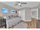 Comfortable bedroom with hardwood floors, a daybed, and ample natural light from multiple windows at 9705 Cameo Rose Ln, Las Vegas, NV 89134