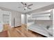 Bedroom with hardwood flooring, a white bunk bed, and a chest of drawers at 9705 Cameo Rose Ln, Las Vegas, NV 89134