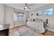 Bright bedroom with hardwood floors, three windows, and a comfortable daybed at 9705 Cameo Rose Ln, Las Vegas, NV 89134