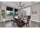 Inviting dining room with tile floors, views to the outside, modern ceiling fan and natural light, perfect for Gathering gatherings at 9705 Cameo Rose Ln, Las Vegas, NV 89134