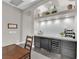 Stylish dining area featuring custom cabinets, a wine fridge, and a cozy built-in alcove at 9705 Cameo Rose Ln, Las Vegas, NV 89134
