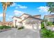 Inviting two-story home featuring a well-maintained lawn, three-car garage, and stylish architecture at 9705 Cameo Rose Ln, Las Vegas, NV 89134
