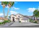 Beautiful two-story home with a three-car garage, landscaped front yard and elegant entrance at 9705 Cameo Rose Ln, Las Vegas, NV 89134