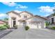 Charming home with a three-car garage, landscaped garden, and welcoming front entrance at 9705 Cameo Rose Ln, Las Vegas, NV 89134