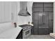 Contemporary kitchen with a stainless steel range hood, modern appliances, and ample counter space at 9705 Cameo Rose Ln, Las Vegas, NV 89134